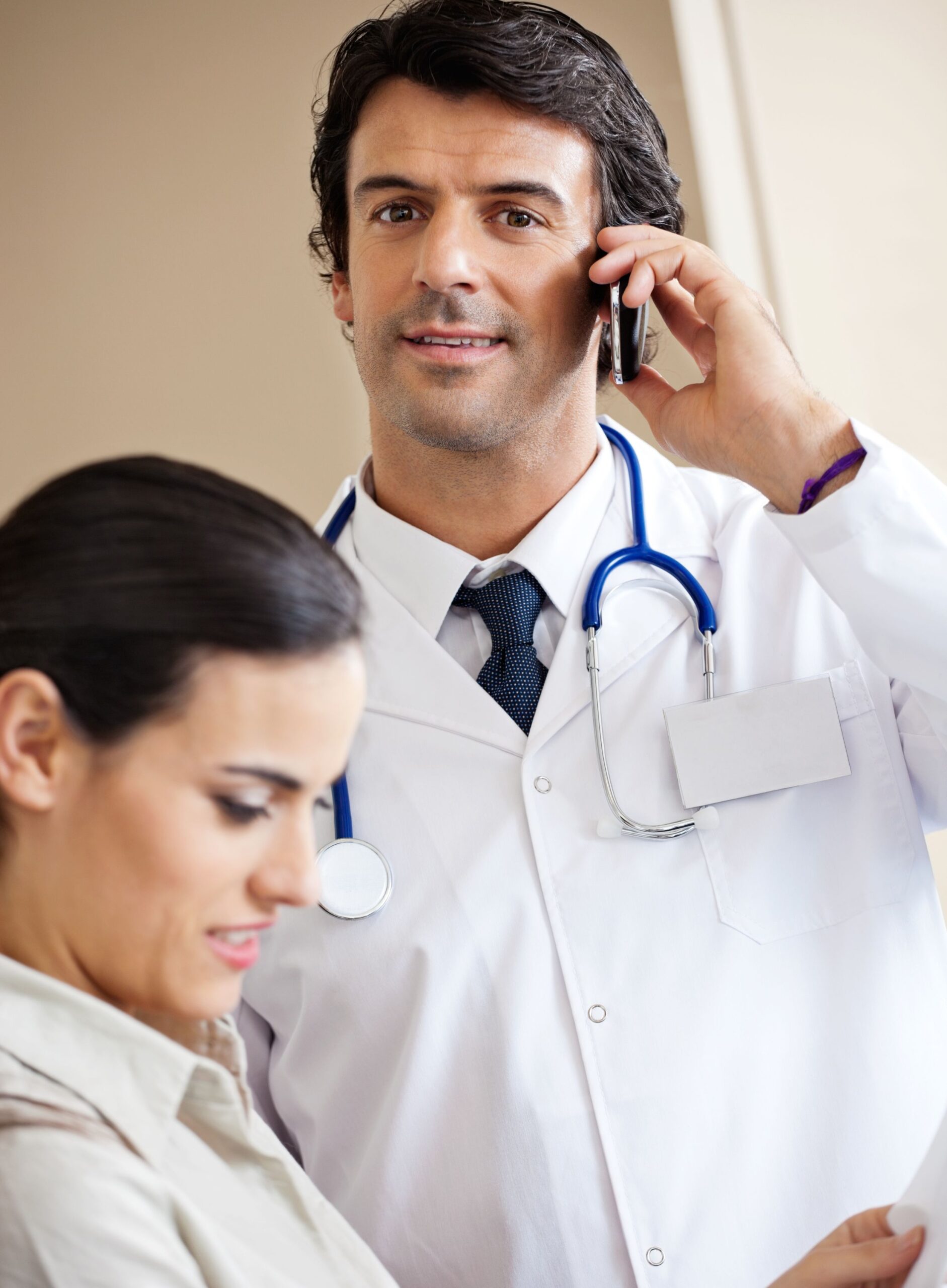 Doctor answering a call in a private office, adhering to HIPAA guidelines.