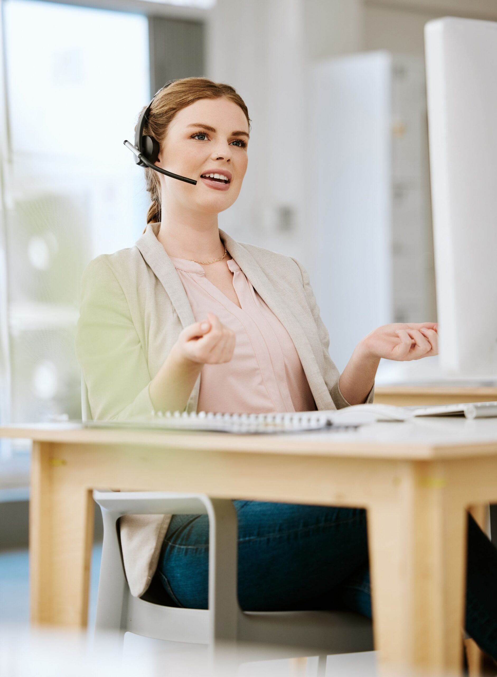 A dedicated woman working remotely in a tech support call center, wearing a headset and focused on providing top-quality technical assistance.