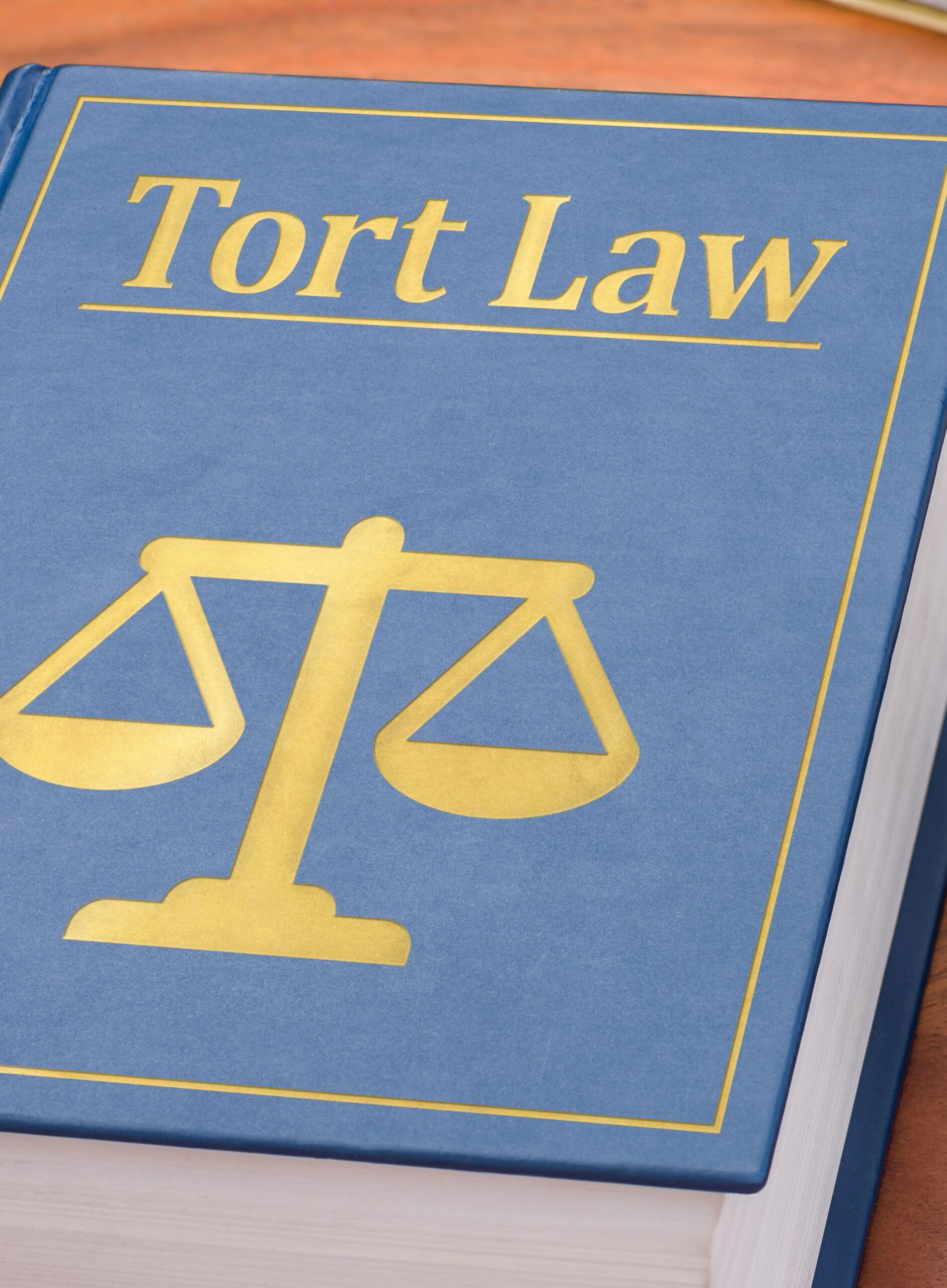 A book titled "Tort Law" prominently displayed, highlighting the specialized focus of mass tort law firms.